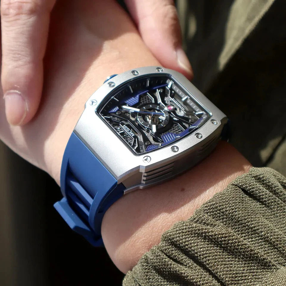 Close-up of a person wearing a watch with a blue strap and silver case.