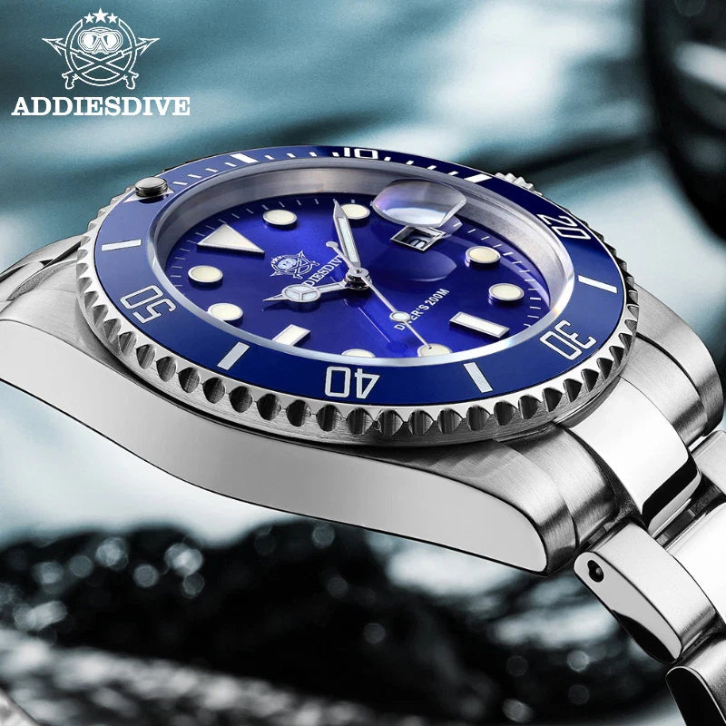 Silver watch with blue dial on a blurred water background, featuring the Addiesdive brand.