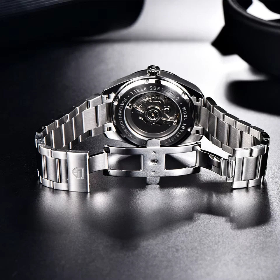 Silver watch with a detailed face on a dark surface