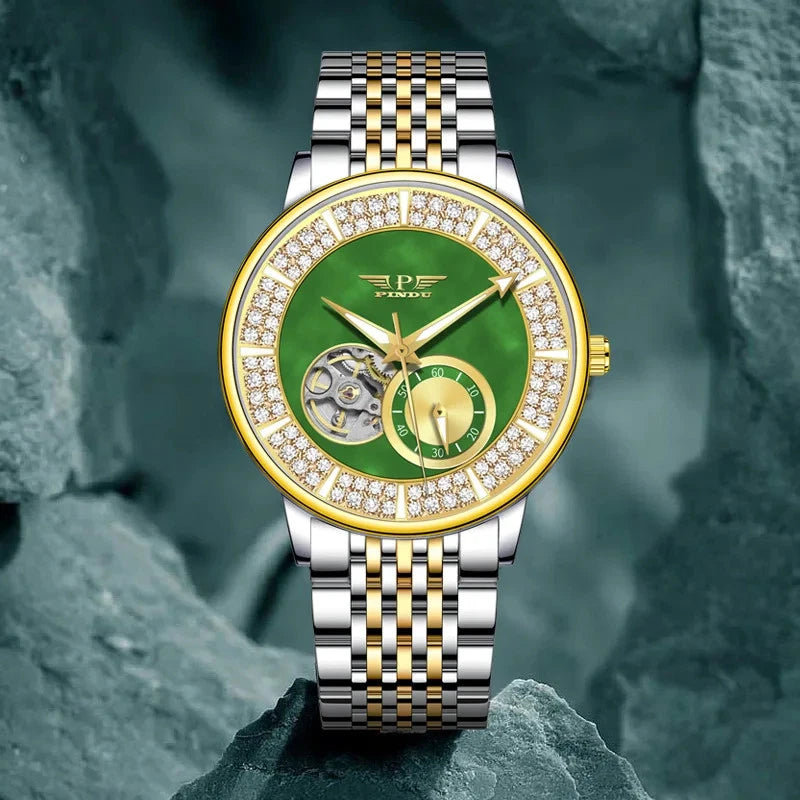 Luxury watch with green face and diamond-studded bezel on a rocky background