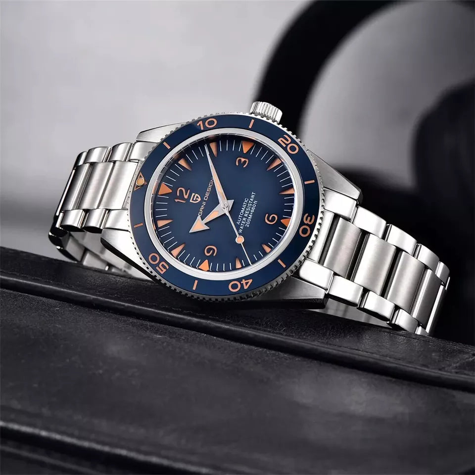 Silver watch with a blue dial on a dark surface