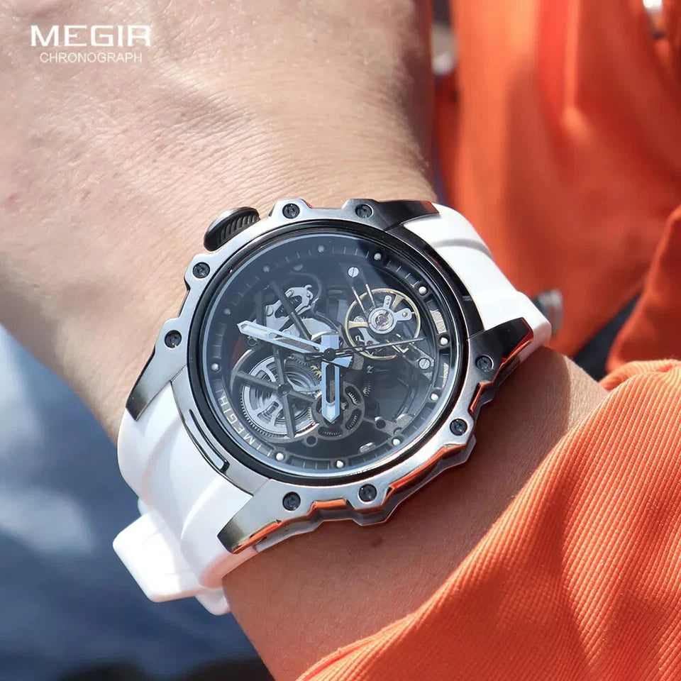 White and black Megia chronograph watch on a wrist with an orange shirt background