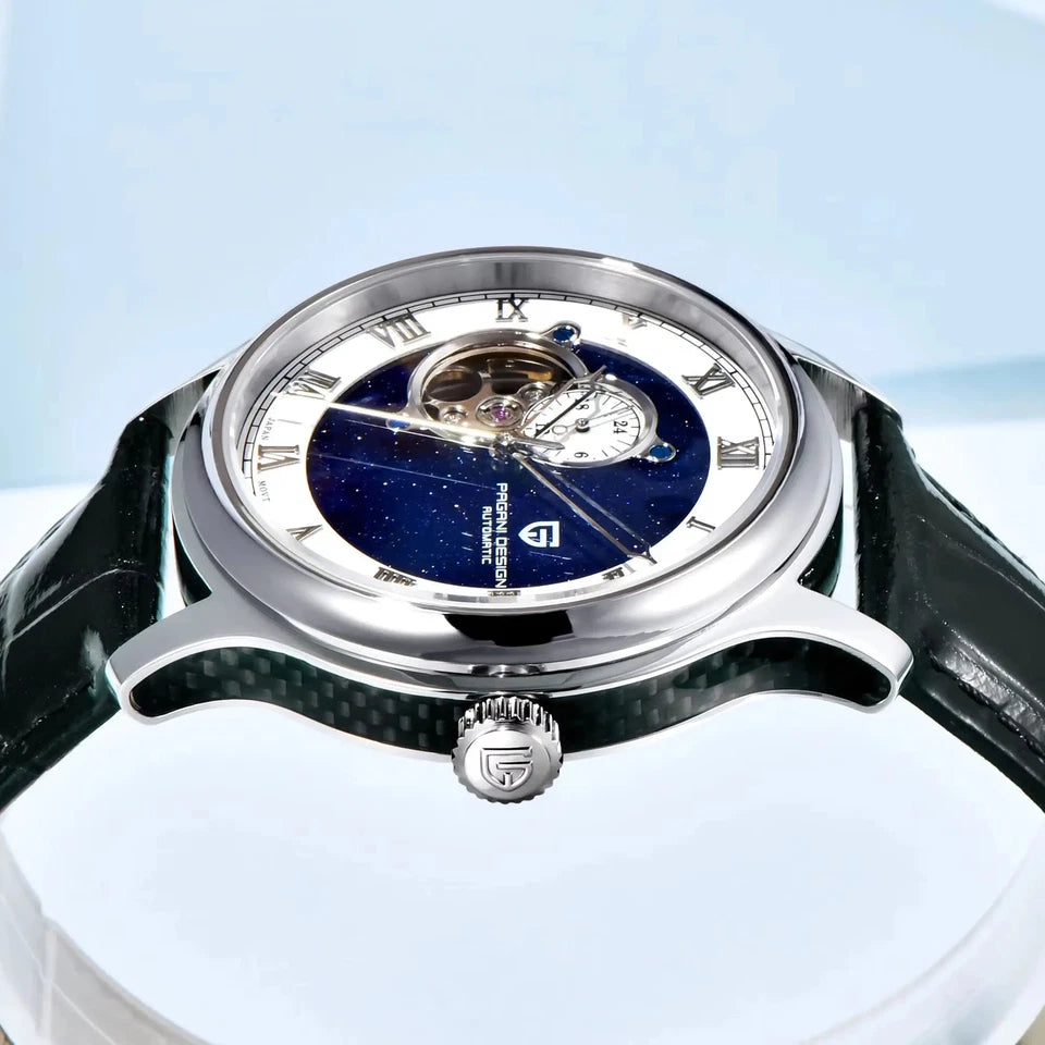 Luxury watch with a blue face and silver case on a light blue background