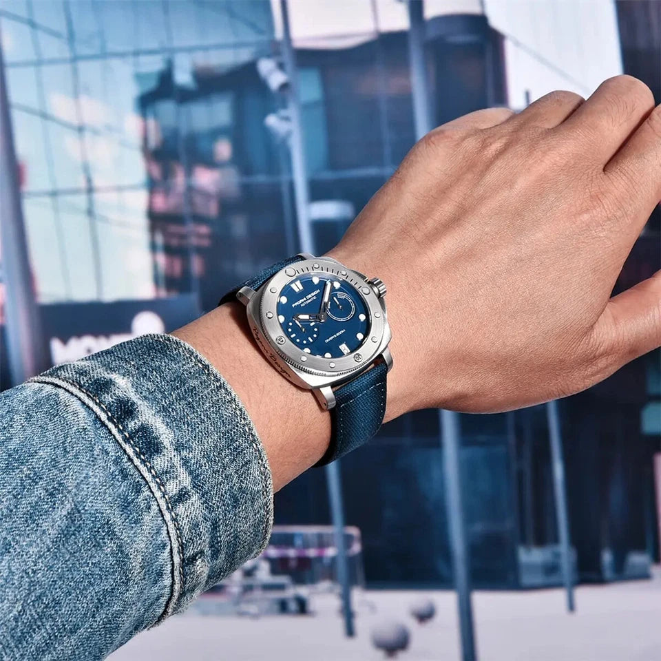 Hand wearing a blue watch with a blurred cityscape background