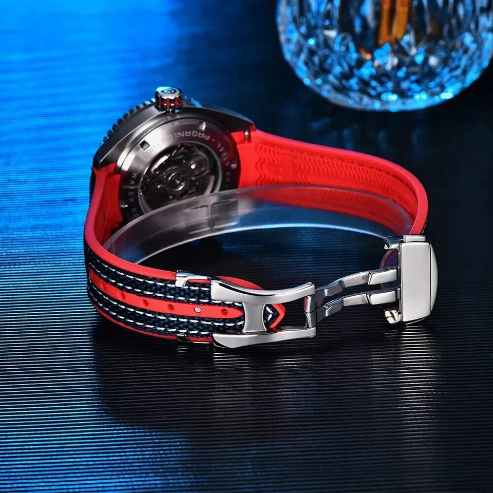 Watch with red and black strap on a reflective blue surface