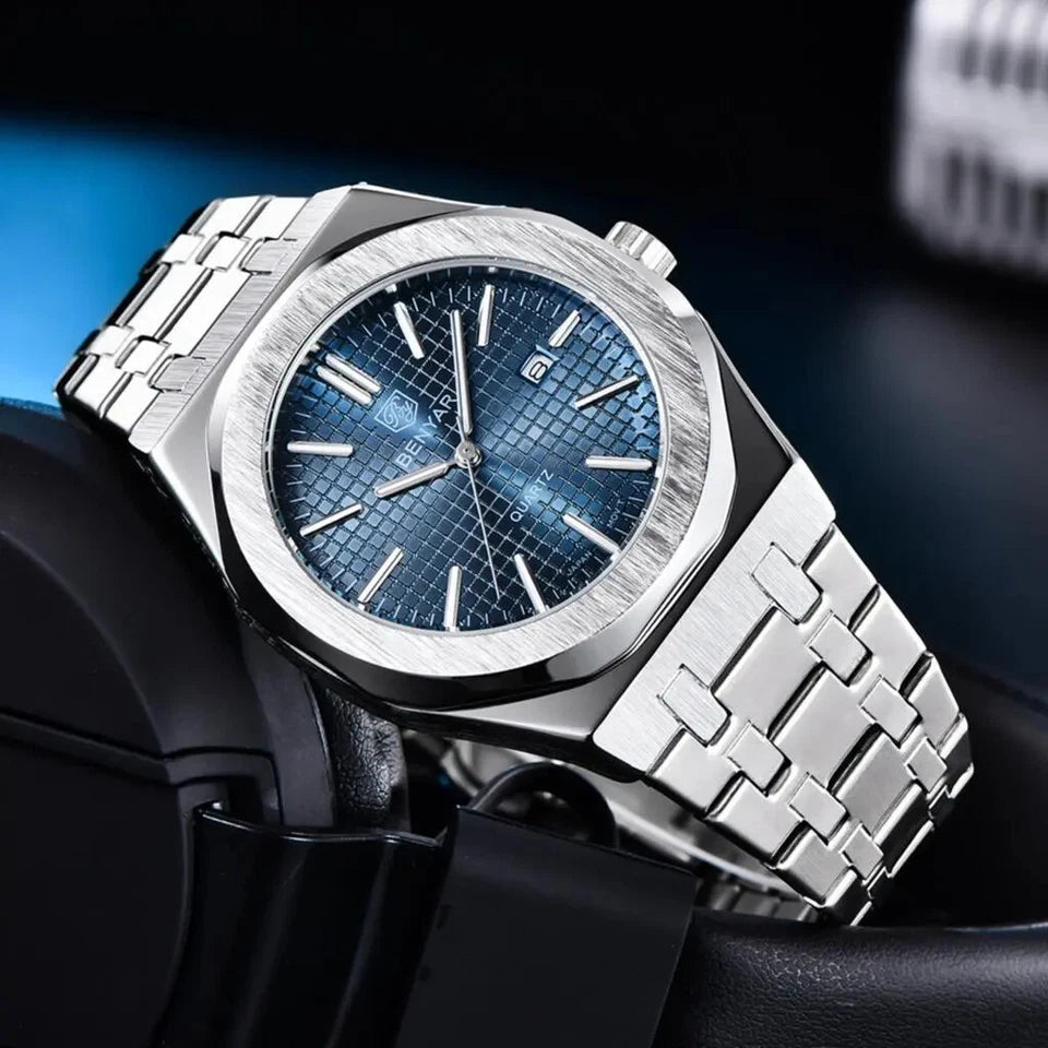 Silver watch with blue face on a dark background