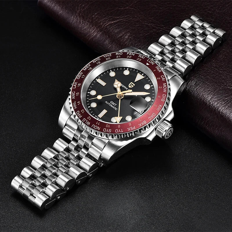 Silver wristwatch with a red and black face on a dark background
