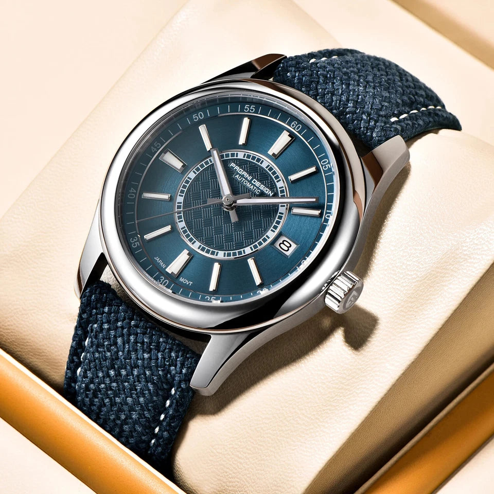 Wristwatch with blue strap and blue dial on a beige surface