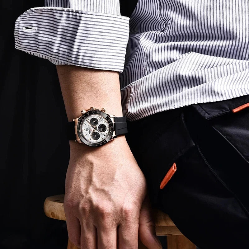 Person wearing a watch with a striped shirt and black pants.