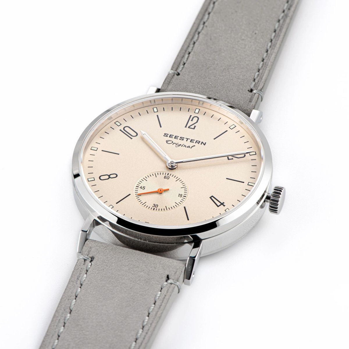 Seestern S382 cream dial watch at three-quarter angle on grey suede strap, white background