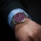 Seestern S382 purple dial dress watch on grey suede strap worn on the wrist, close-up lifestyle