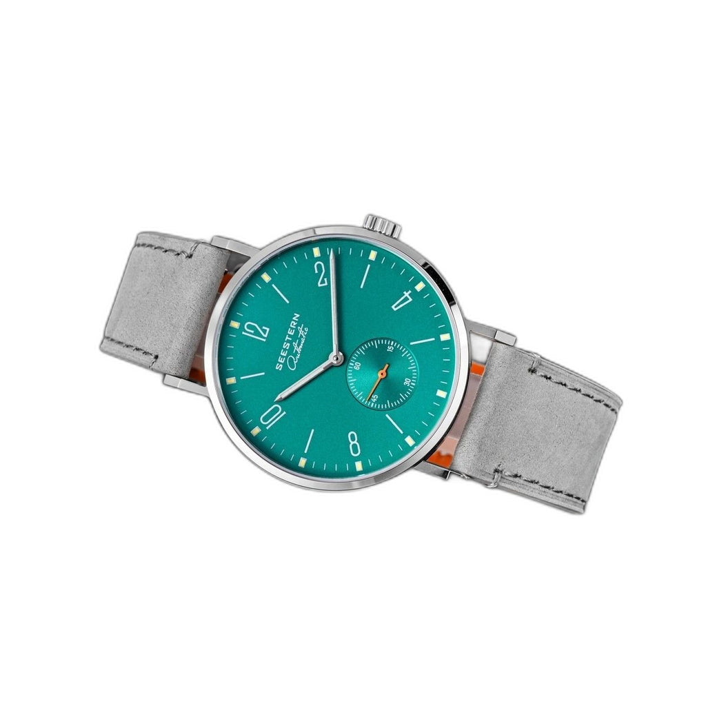 Seestern S382 turquoise dial dress watch on grey suede strap, floating angled studio view