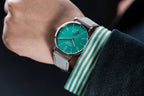 Seestern S382 turquoise dial dress watch on grey suede strap on the wrist with striped cuff, lifestyle