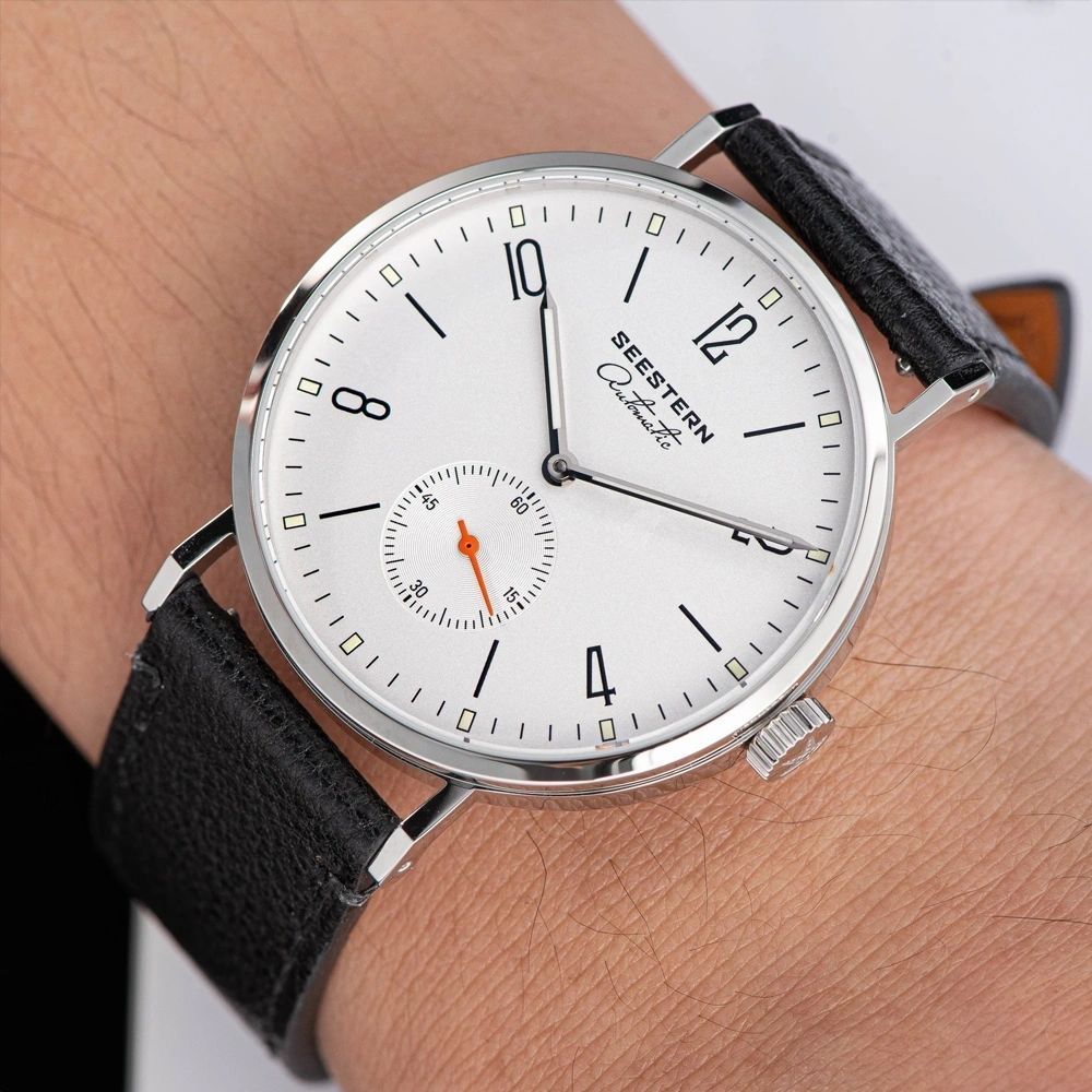 Seestern S382 silver-white dial dress watch on black leather strap worn on the wrist, close-up