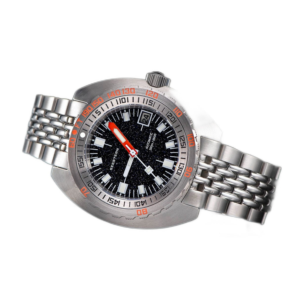 Seestern S406 aventurine starry dial diver on steel bracelet resting on leather, angled shot
