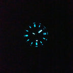 Seestern S406 diver dial glowing blue-green lume in the dark, close-up second lume shot