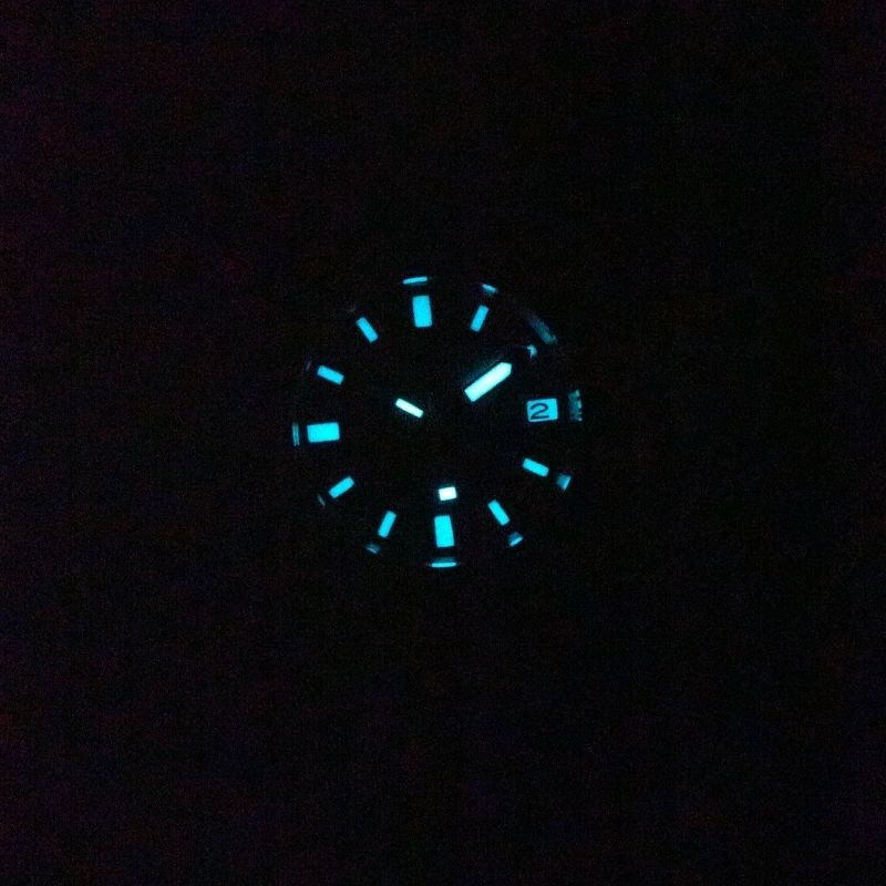Seestern S406 diver dial glowing blue-green lume in the dark, close-up second lume shot