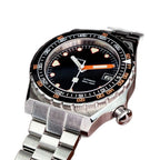 Seestern S407 black ceramic diver on steel bracelet resting on brown leather, angled shot