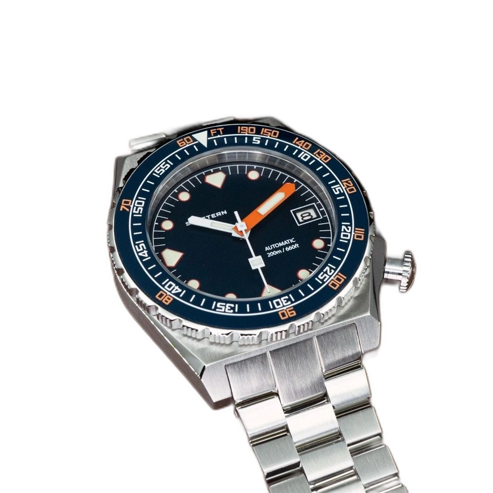 Seestern S407 dark blue ceramic diver on steel bracelet resting on brown leather, angled view