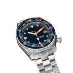 Seestern S407 dark blue ceramic diver on steel bracelet resting on brown leather, angled view