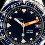 Seestern S407 dark blue dial macro showing SEESTERN print, orange hand and date window
