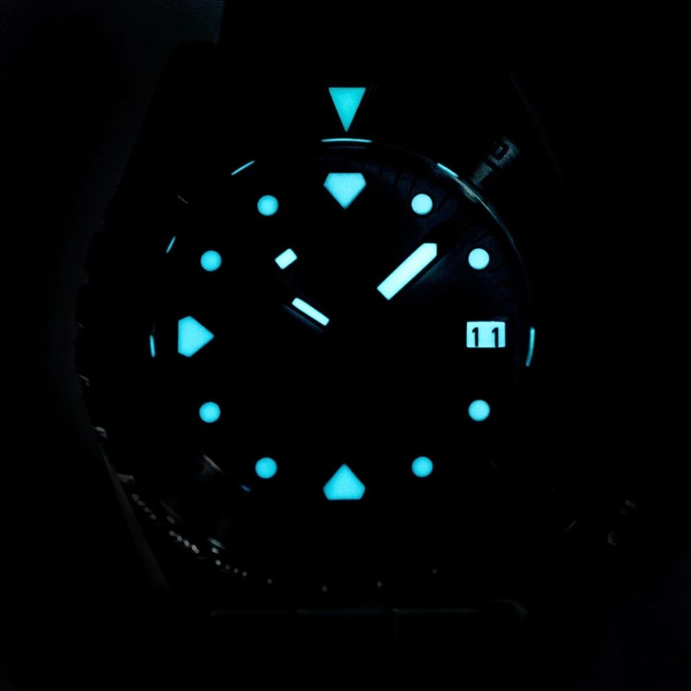 Seestern S407 diver dial glowing blue-green lume in the dark, applied markers illuminated