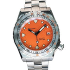 Seestern S407 orange ceramic diver on steel bracelet resting on brown leather, angled view