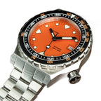 Seestern S407 orange ceramic diver on steel bracelet, angled view on brown leather