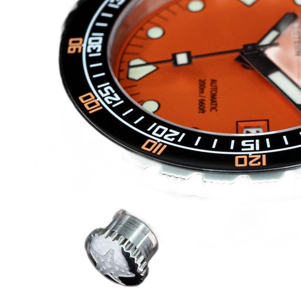 Seestern S407 screw-down crown macro with star logo, orange dial and black bezel cropped behind