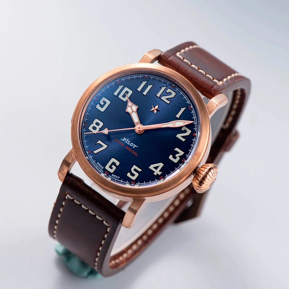 Seestern S408 bronze pilot, blue sunburst dial and brown leather strap, dramatic angled studio view