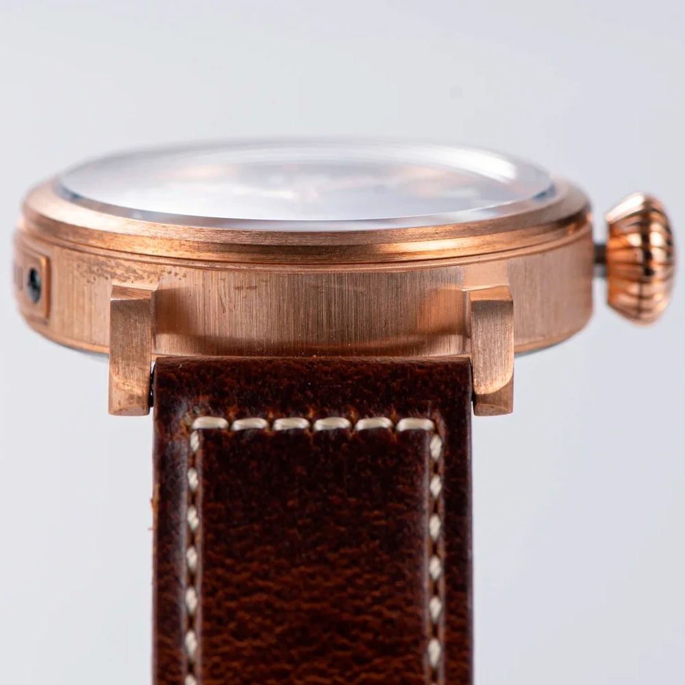 Seestern S408 close side view of the bronze case, lugs and brown stitched leather strap