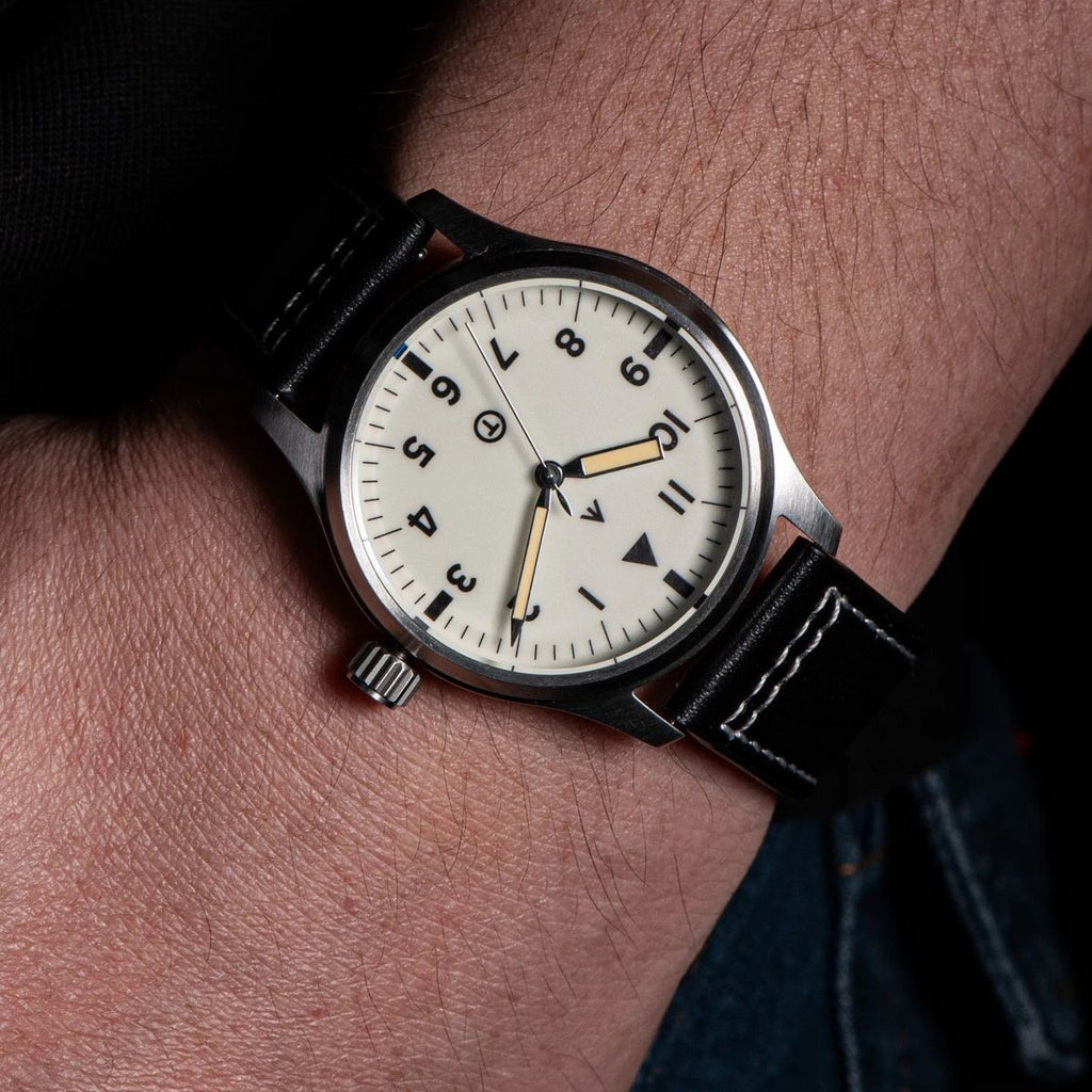 Seestern S424 cream-dial flieger pilot watch worn on wrist with black leather strap, close-up angle