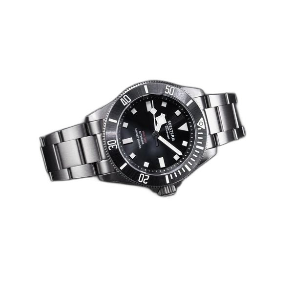 Seestern S430 black-dial titanium diver on bracelet resting on dark textured surface, angled view