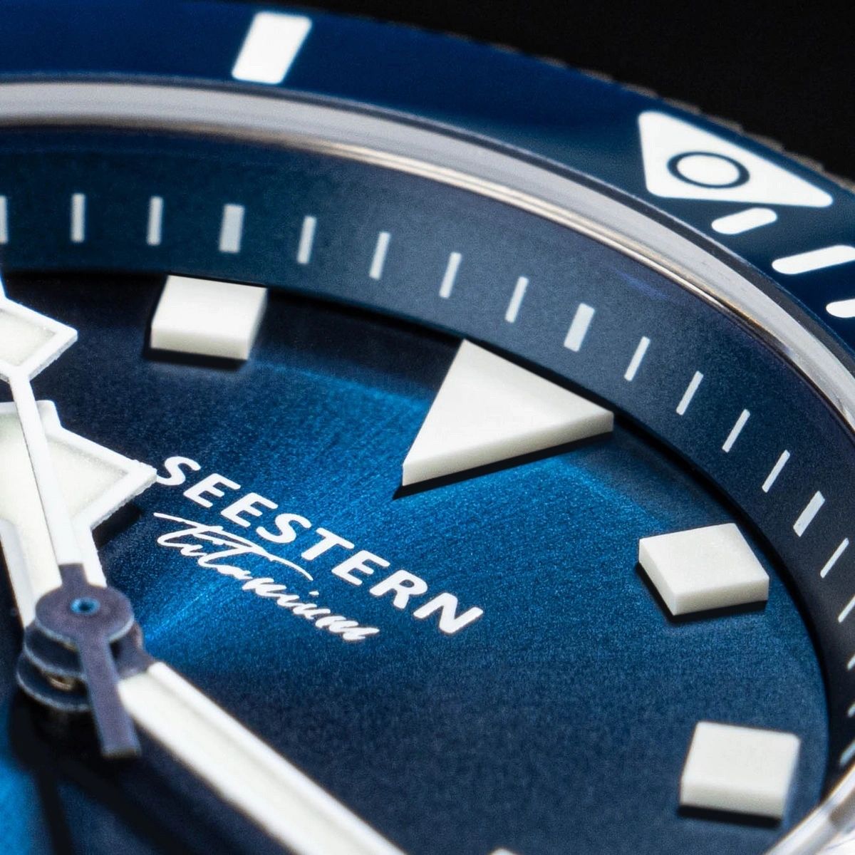 Seestern S430 blue dial extreme macro showing SEESTERN Titanium print, applied markers and triangle