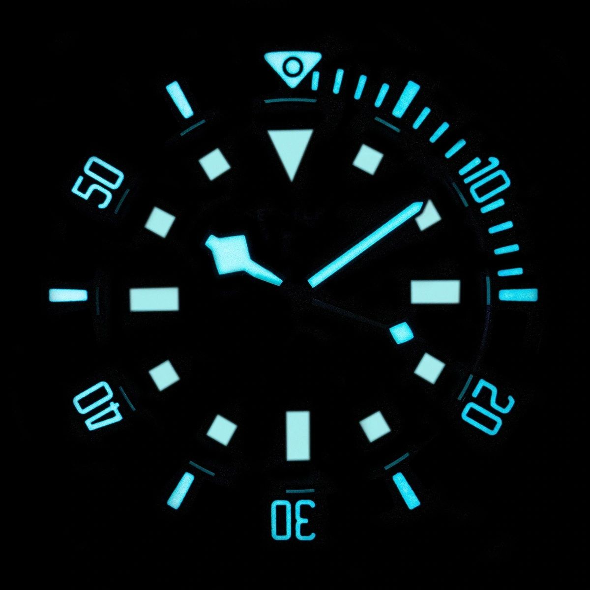 Seestern S430 diver dial glowing blue-green lume in the dark, markers and dive bezel illuminated