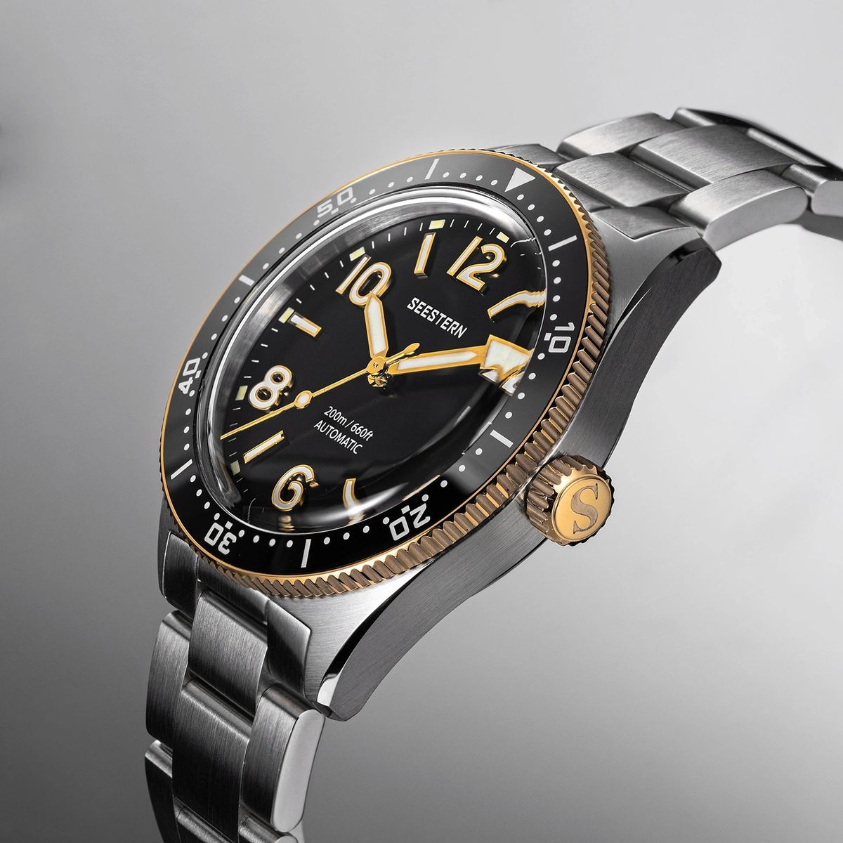 Seestern S434-2 black-and-gold skin diver on steel bracelet, angled studio view