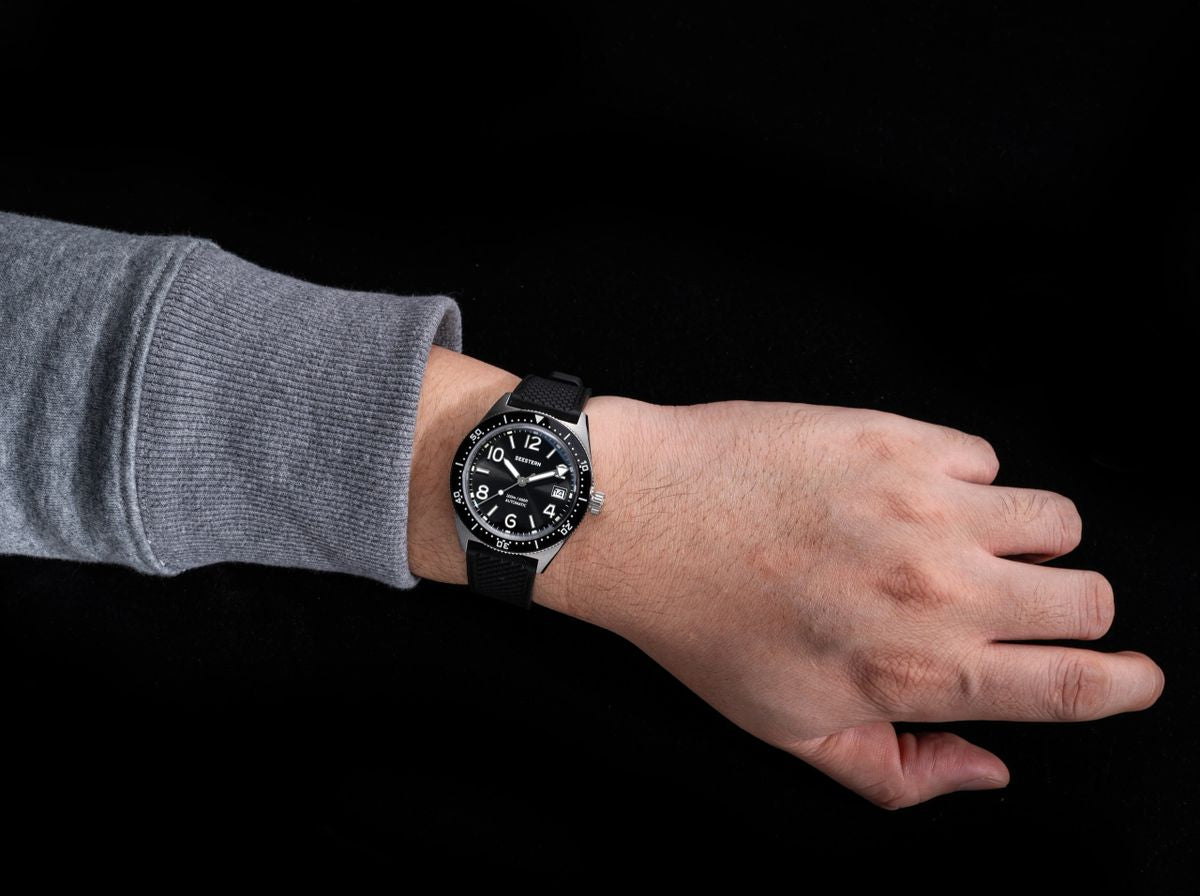 Seestern S434-2 black-dial skin diver worn on wrist with black rubber strap, close-up