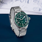 Seestern S434-2 green-dial skin diver, green bezel, steel bracelet, angled view on blue