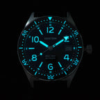 Seestern S434-2 skin diver dial and bezel glowing blue-green lume in the dark, close-up
