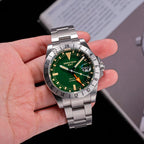 Seestern S436-2 green-dial vintage GMT held in hand, steel bracelet, close-up product view