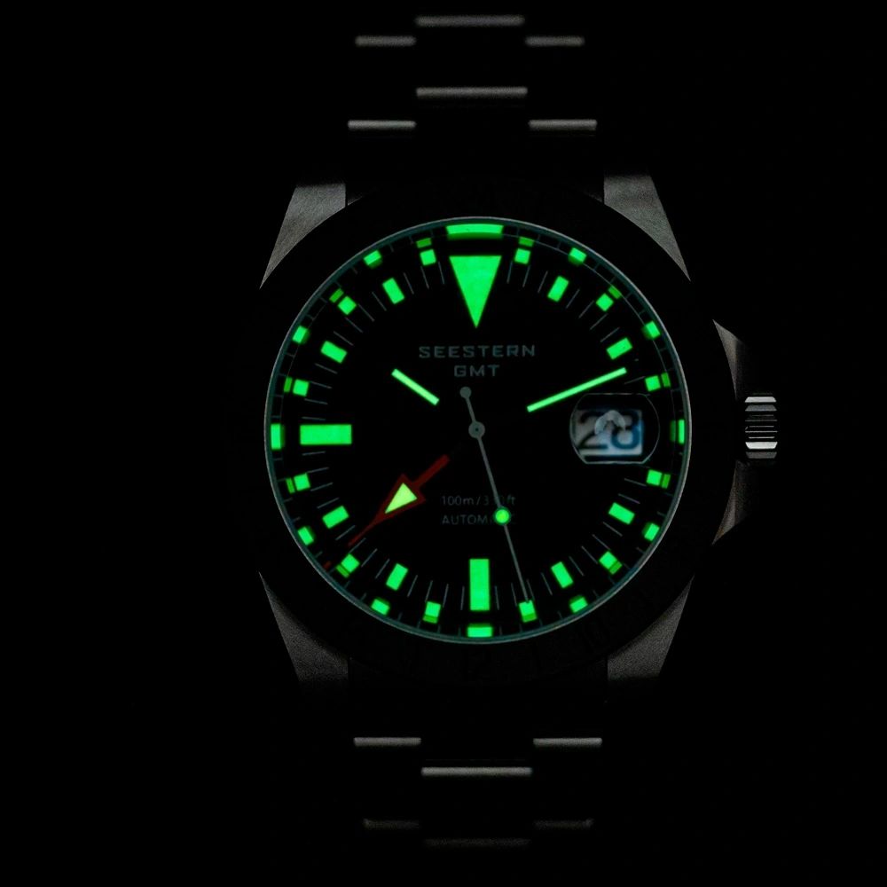 Seestern S436-2 GMT dial glowing green lume in the dark with date window, second lume shot