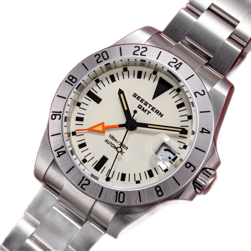 Seestern S436-2 close three-quarter angle of the cream dial, orange GMT hand and date at 3
