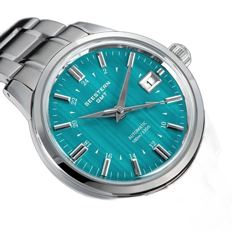 Seestern S446 teal green mint-dial GMT on steel bracelet, angled front studio view