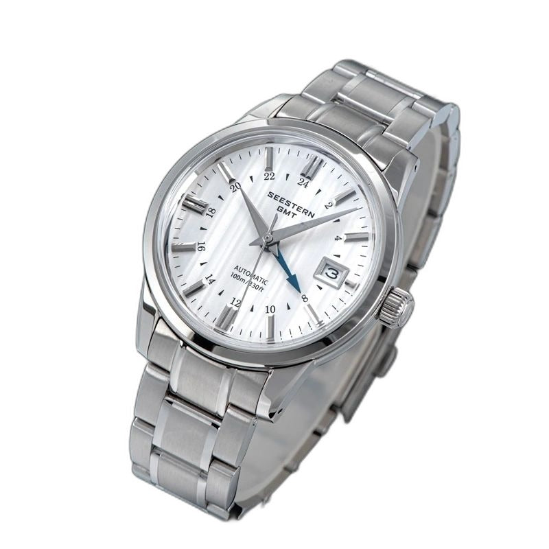 Seestern S446 silver-dial GMT on steel bracelet, angled flat-lay on blue notebook