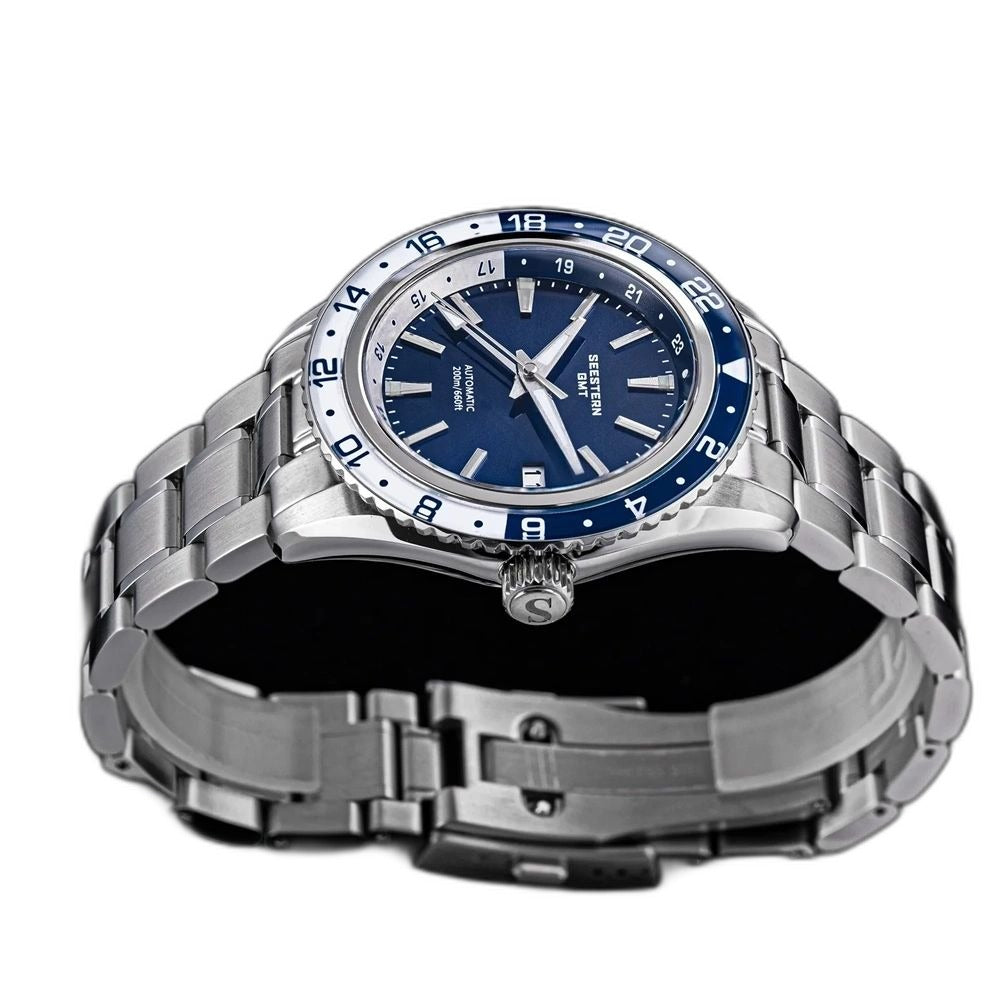 Seestern S456 navy-dial GMT on steel bracelet, three-quarter angled view with starfish screw crown