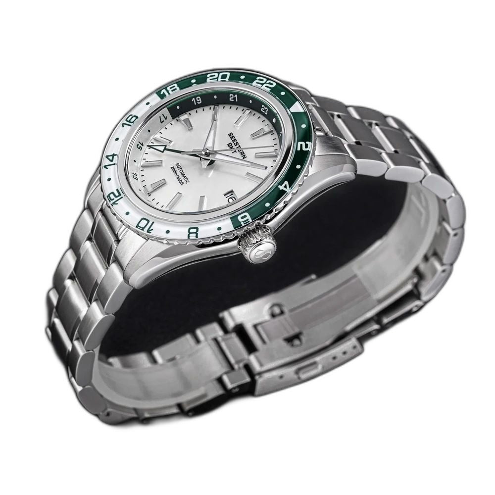 Seestern S456 white MOP-dial GMT with green bezel on steel bracelet, angled studio view