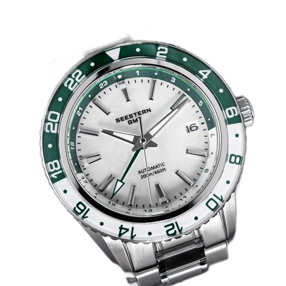 Seestern S456 white MOP-dial GMT with green bezel on steel bracelet, dramatic angled view