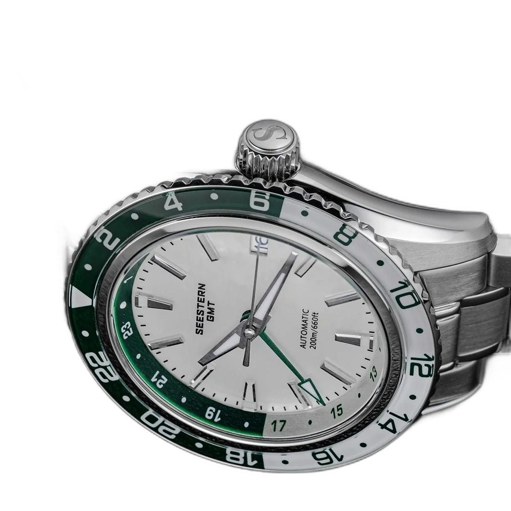 Seestern S456 white MOP-dial GMT with green bezel, low-angle close-up with starfish crown