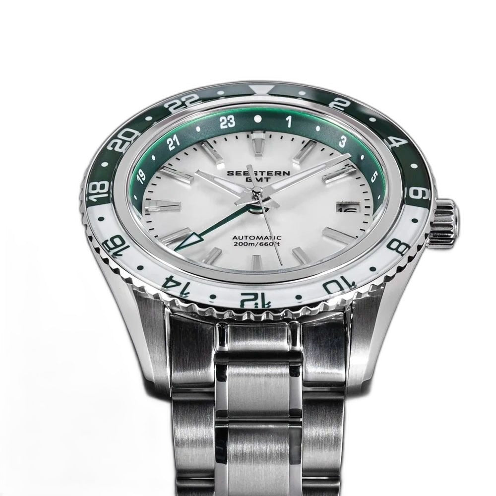 Seestern S456 white MOP-dial GMT with green bezel on steel bracelet, three-quarter angled view