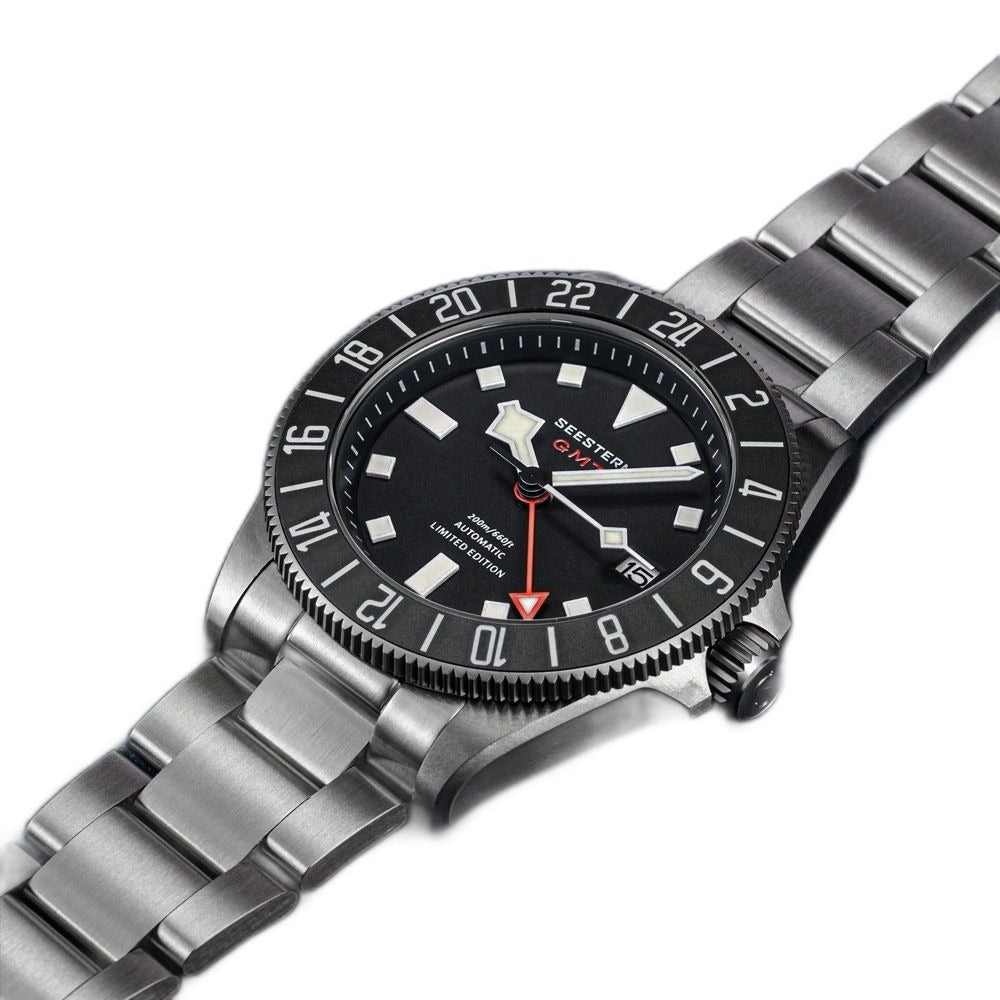 Seestern S462 titanium GMT, black dial, three-quarter angled view on navy leather, steel bracelet